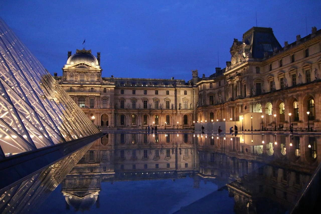 The Louvre Pyramid and palace at blue hour